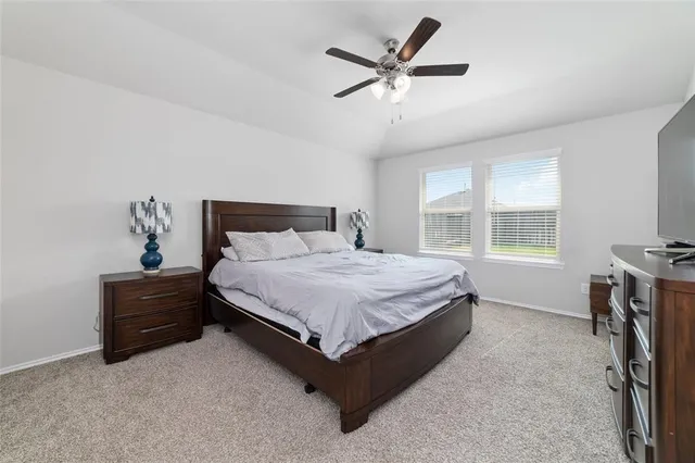 a bedroom with a bed dresser and a window
