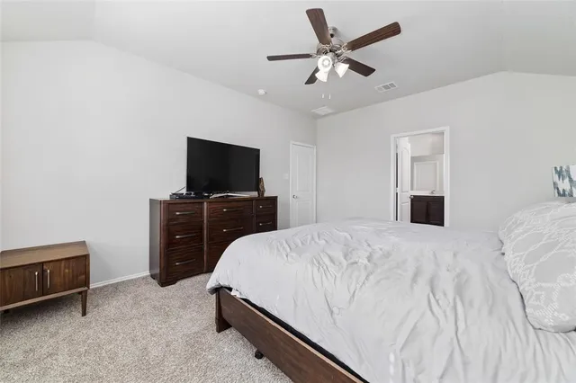 a bed room with a bed and a tv