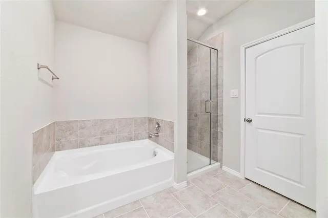 a bathroom with a bathtub and shower