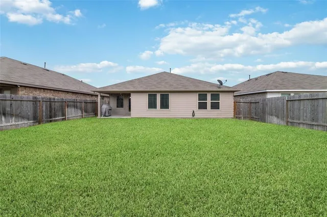 a view of a house with a back yard