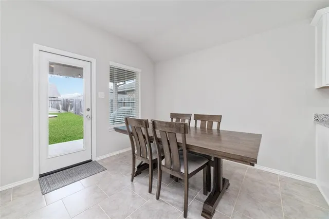 a view of a dining room with furniture and a window