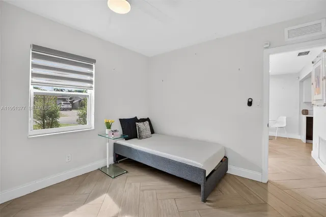 a bedroom with a bed and a window