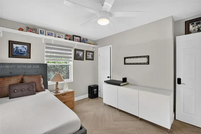 a bedroom with a bed and a large window