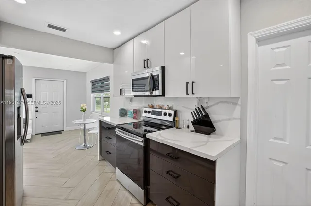 a kitchen with a sink stove and refrigerator