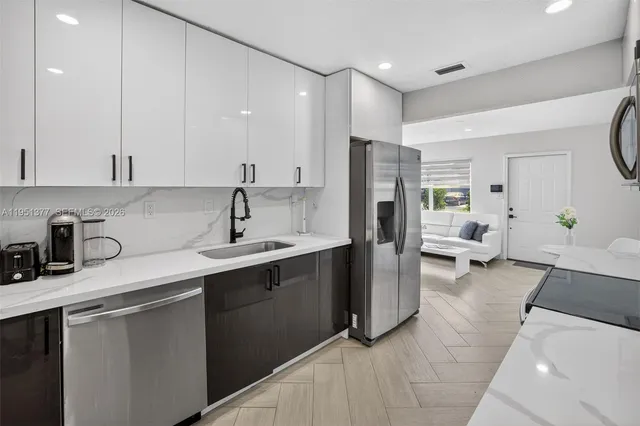 a kitchen with a sink appliances and cabinets