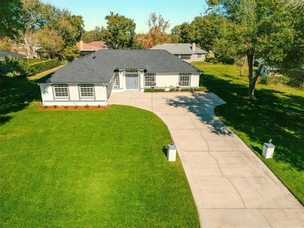 a aerial view of a house with a yard