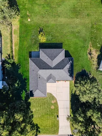 an aerial view of a house with a yard