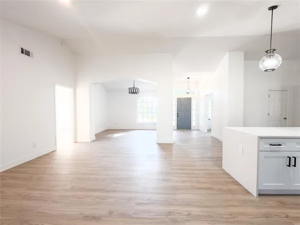 a view of a kitchen with a dishwasher and wooden floor