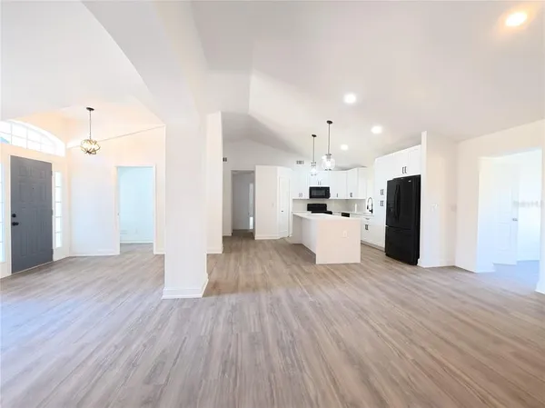 a view of a kitchen with a sink and a refrigerator