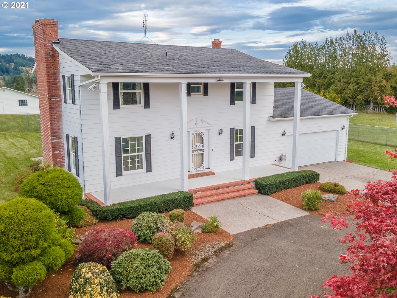 22835 Southeast Tillstrom Road Damascus, OR 97089 - Photo 1 of 32 a front view of a house with a yard and garage