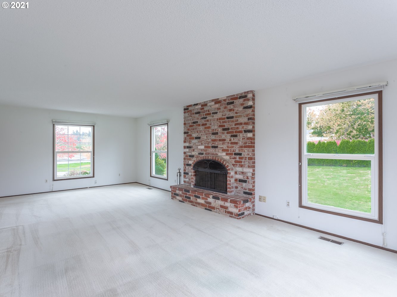 22835 Southeast Tillstrom Road Damascus, OR 97089 - Photo 13 of 32 an empty room with windows and fireplace