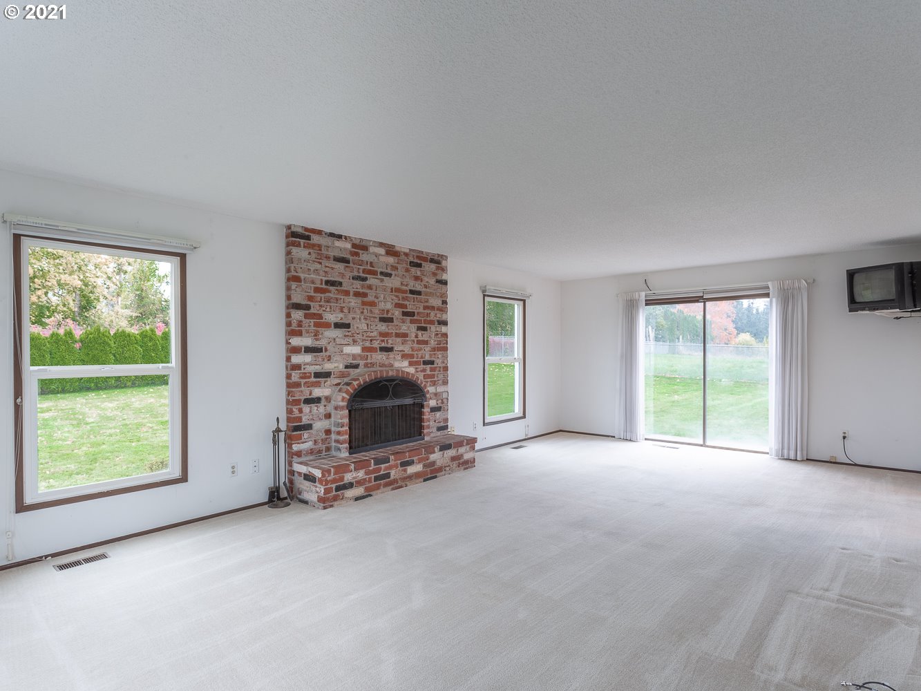 22835 Southeast Tillstrom Road Damascus, OR 97089 - Photo 15 of 32 a view of an empty room with a fireplace and a window