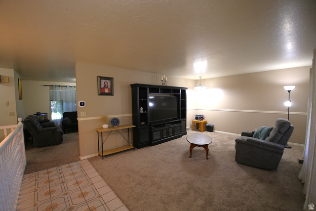 1612 East 450 South Springville, UT 84663 - Photo 10 of 48 Carpeted living area with two-tone wall paint and a chair rail