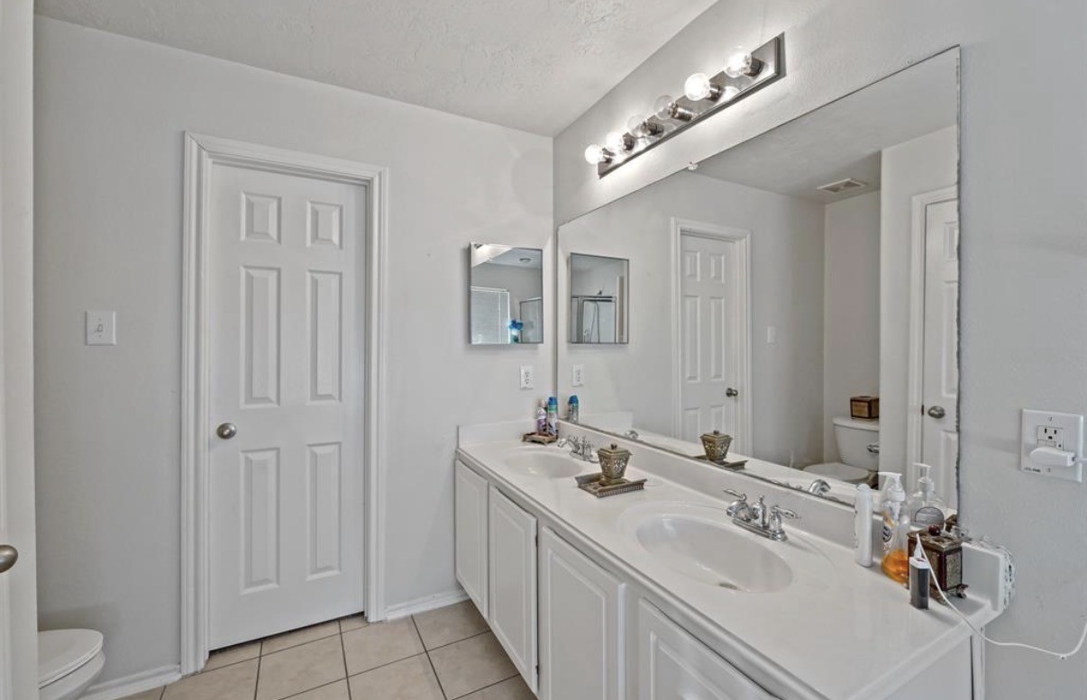13134 Peppergate Lane Houston, TX 77044 - Photo 16 of 23 a bathroom with a sink vanity and mirror
