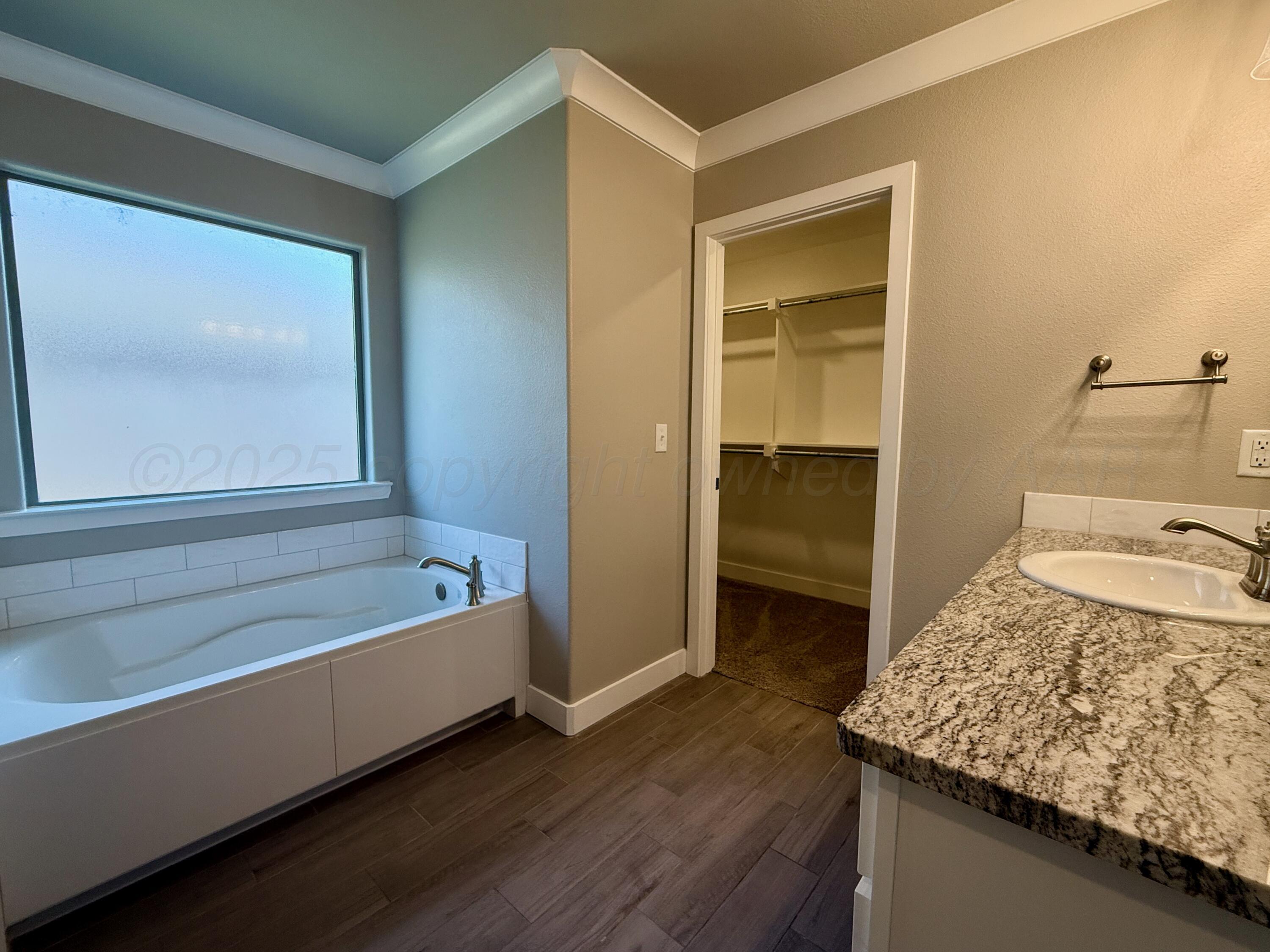 7013 Mercury Trail Amarillo, TX 79118 - Photo 20 of 23 a bathroom with a granite countertop sink and a bathtub