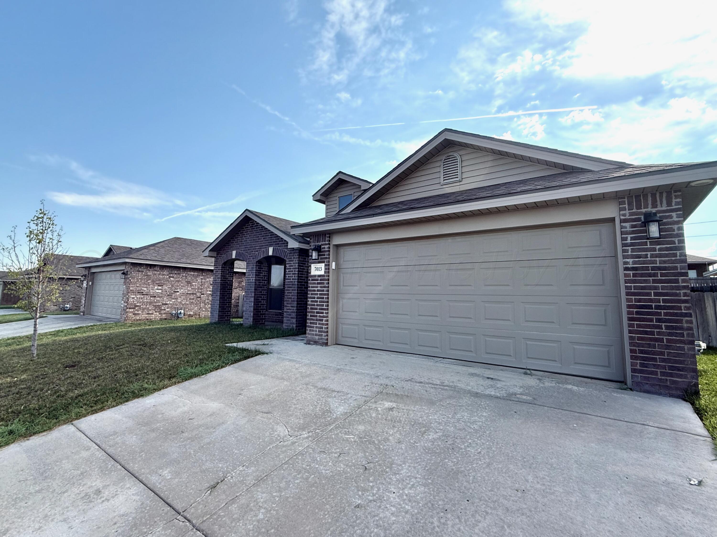 7013 Mercury Trail Amarillo, TX 79118 - Photo 2 of 23 a view of a house with a yard and garage