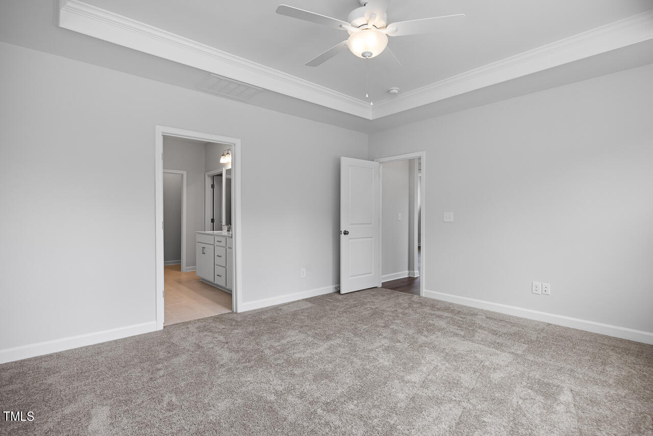 63 Golden Leaf Farms Road, Unit 12 Angier, NC 27501 - Photo 17 of 25 a view of an empty room with a chandelier fan