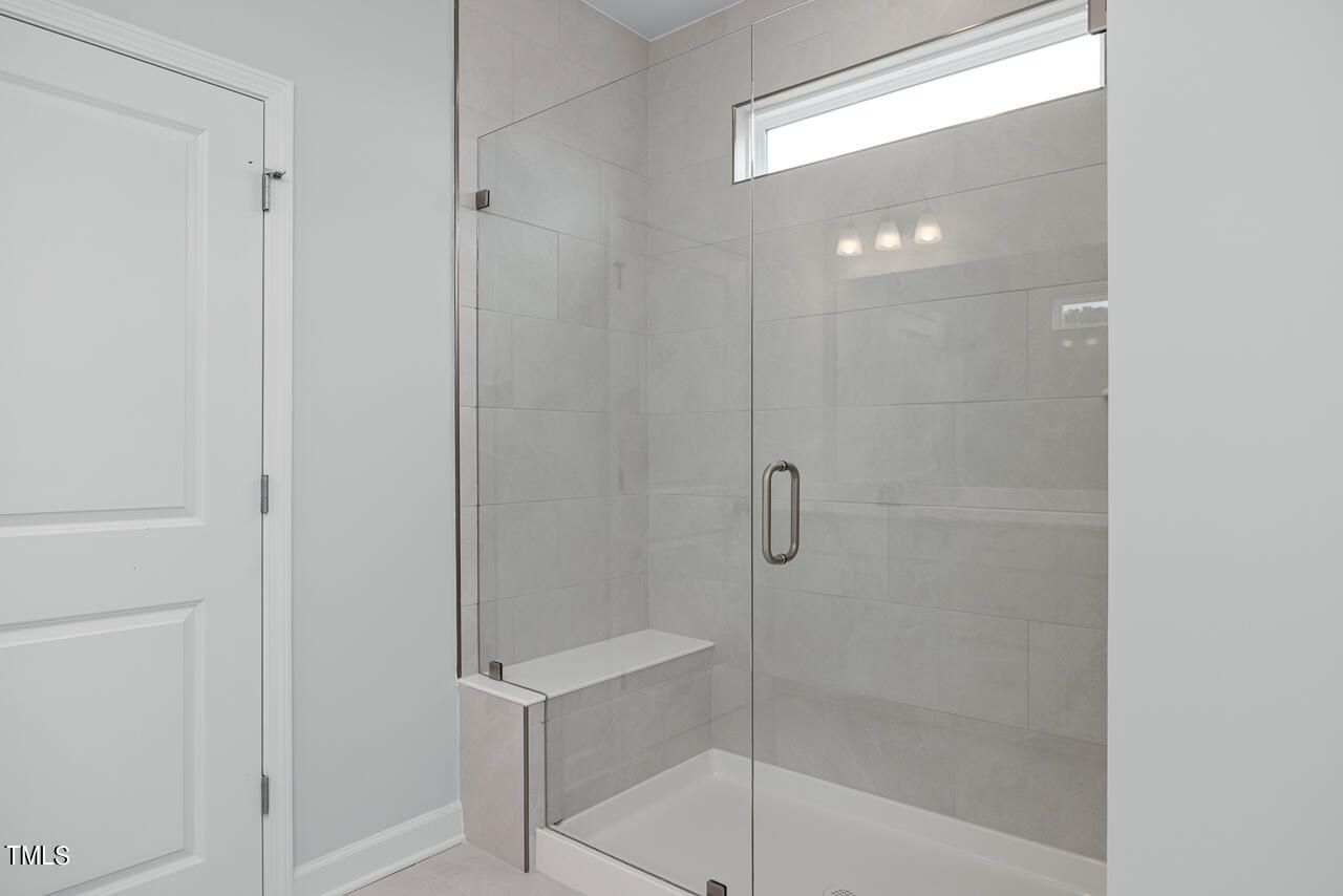 63 Golden Leaf Farms Road, Unit 12 Angier, NC 27501 - Photo 19 of 25 a bathroom with a glass shower door