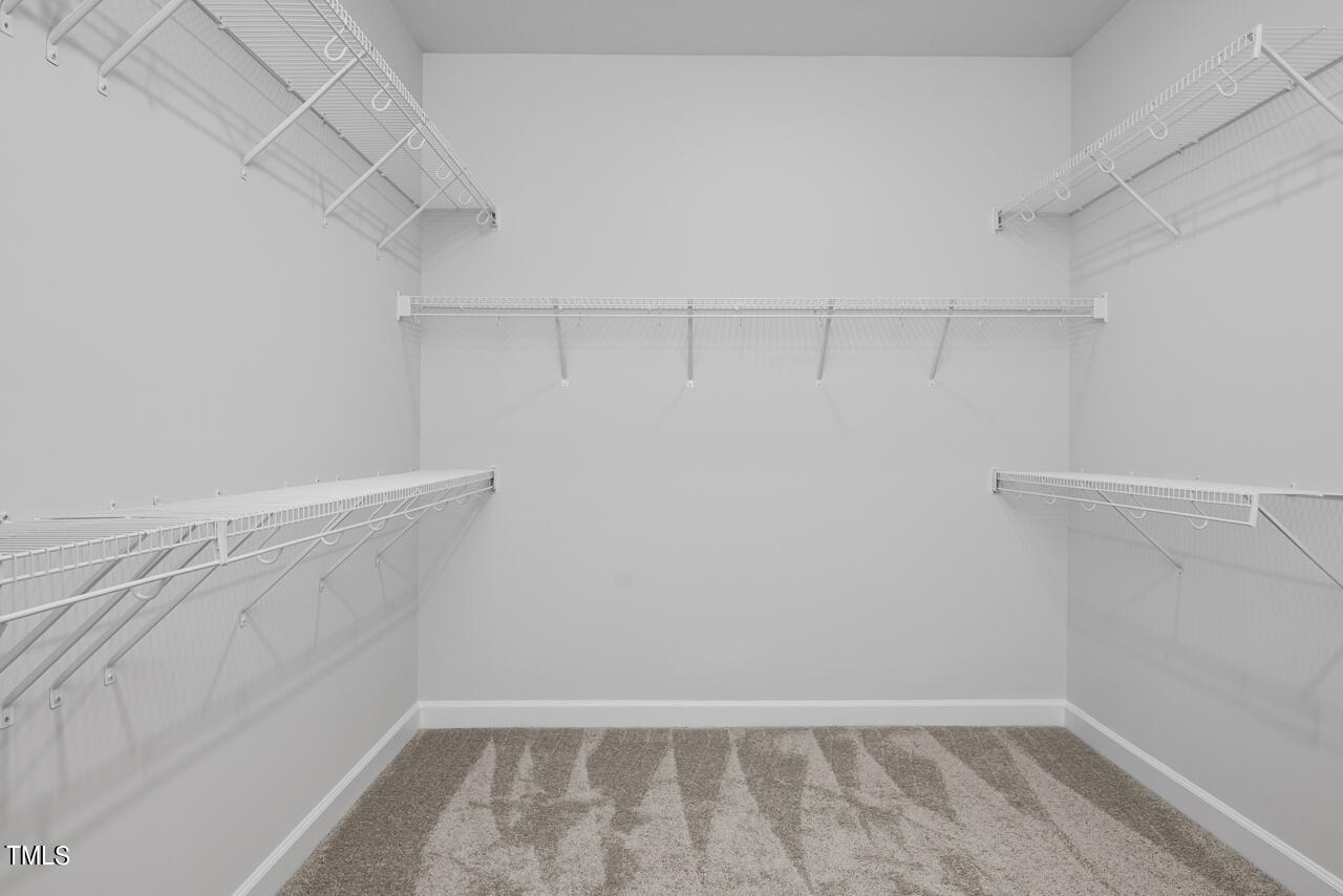 63 Golden Leaf Farms Road, Unit 12 Angier, NC 27501 - Photo 20 of 25 a view of a room with racks on the wall