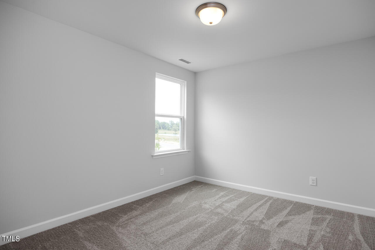 63 Golden Leaf Farms Road, Unit 12 Angier, NC 27501 - Photo 23 of 25 an empty room with windows
