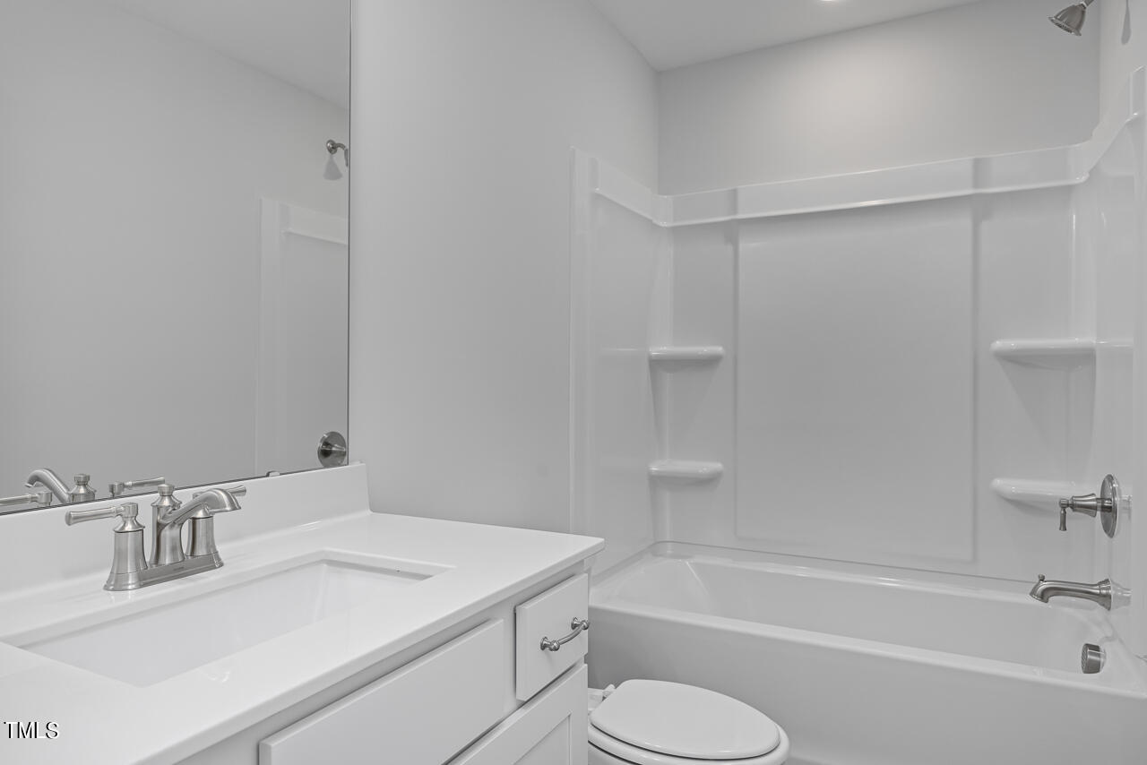 63 Golden Leaf Farms Road, Unit 12 Angier, NC 27501 - Photo 24 of 25 a bathroom with a sink toilet and bathtub