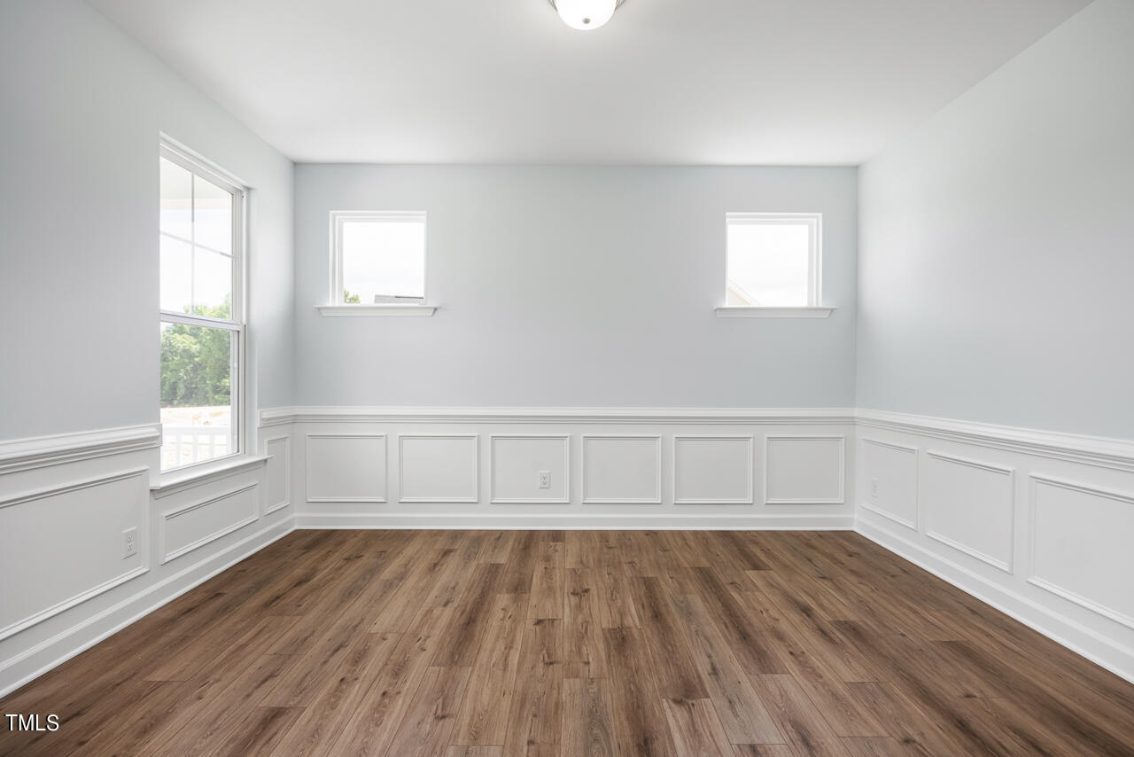 63 Golden Leaf Farms Road, Unit 12 Angier, NC 27501 - Photo 3 of 25 a view of an empty room with wooden floor and a window