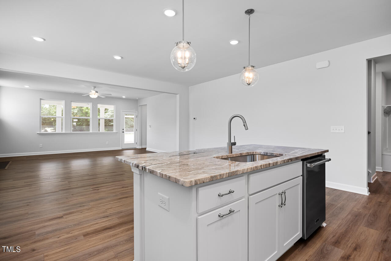 63 Golden Leaf Farms Road, Unit 12 Angier, NC 27501 - Photo 8 of 25 a view of a kitchen counter space a sink and wooden floor
