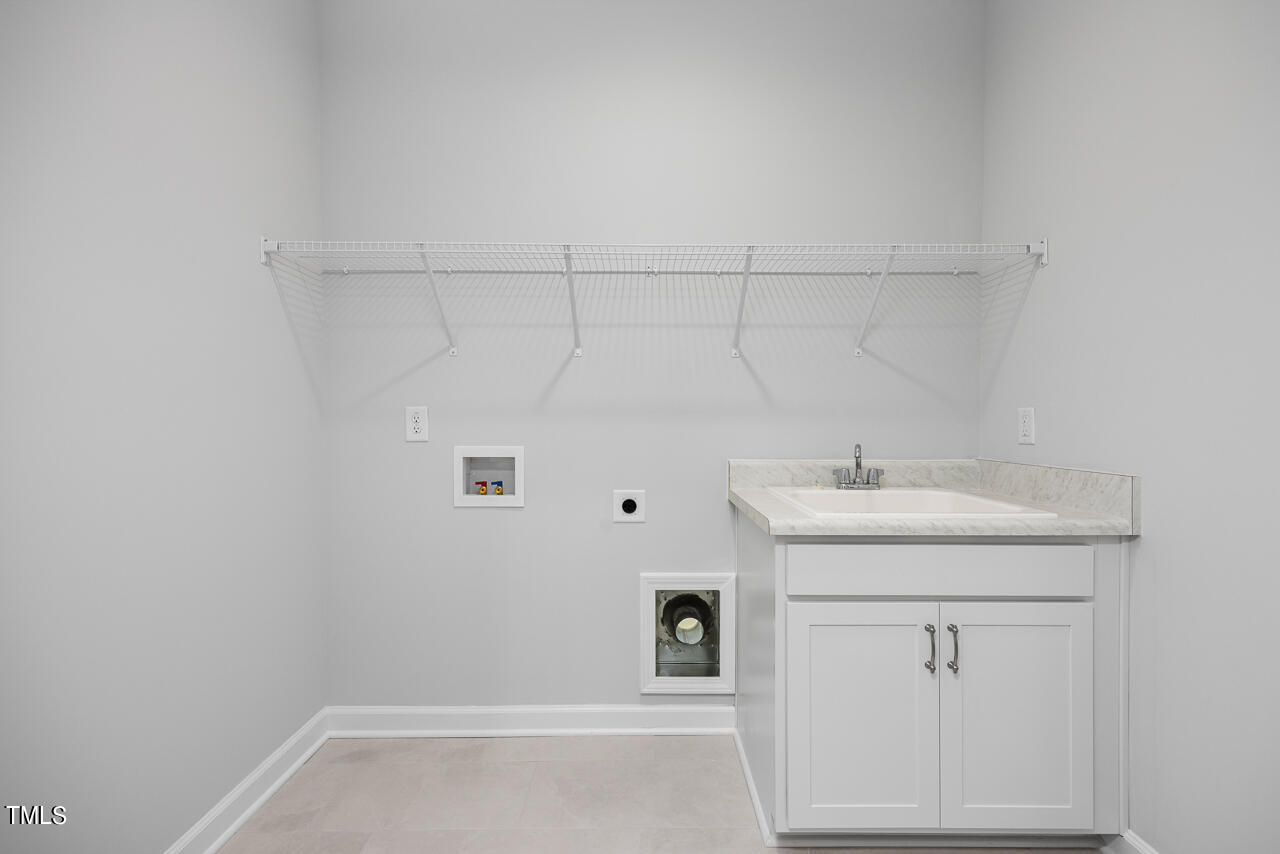 63 Golden Leaf Farms Road, Unit 12 Angier, NC 27501 - Photo 9 of 25 a bathroom with a sink and vanity