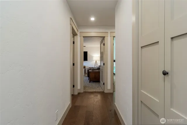 a view of a hallway with a livingroom and a bathroom