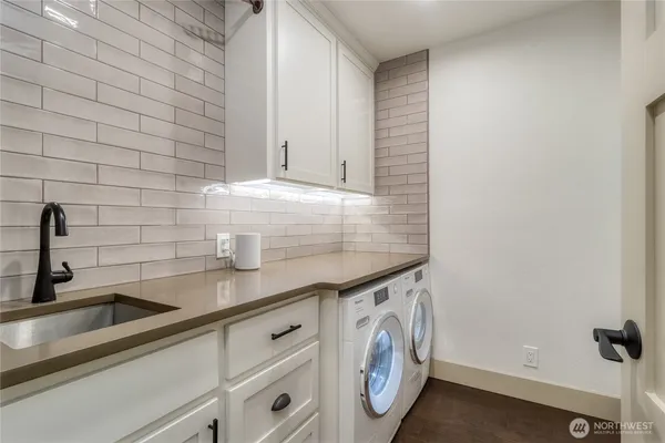 a view of a kitchen sink and cabinets