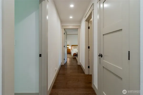 a view of a hallway with a livingroom and a bathroom with a sink