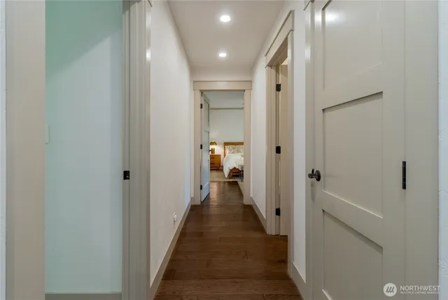 a view of a hallway with a livingroom and a bathroom with a sink