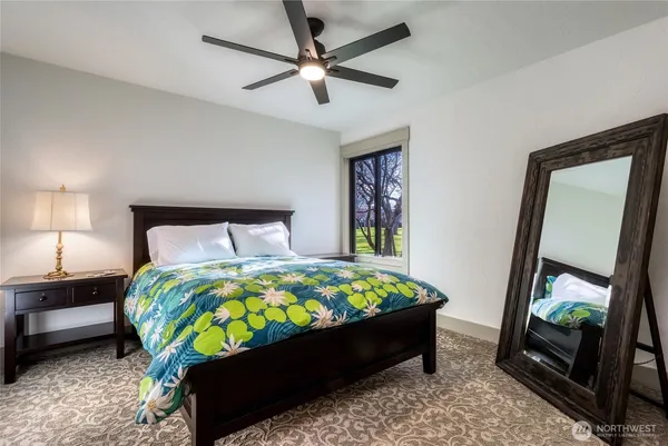 a bed sitting in a bedroom next to a window