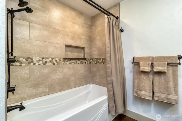 a bathroom with a bathtub and a shower
