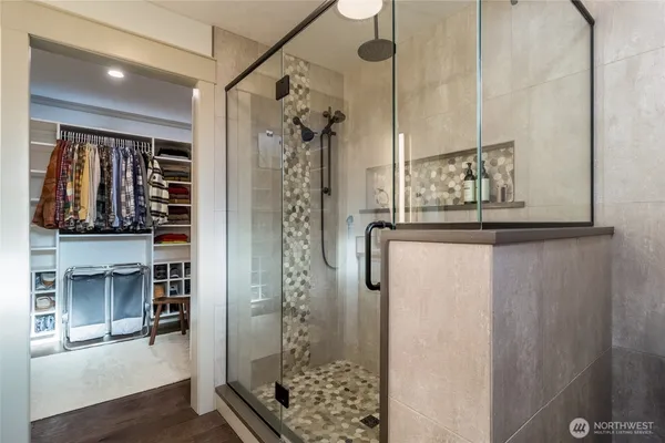 a bathroom with a granite countertop shower a mirror and a sink