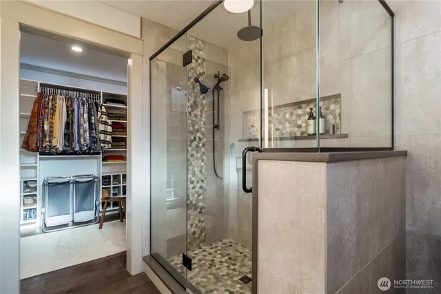a bathroom with a granite countertop shower a mirror and a sink