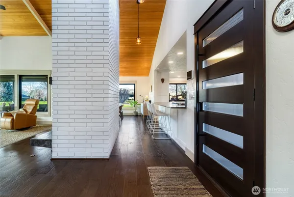a view of a hallway view with wooden floor and windows