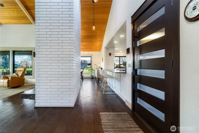 a view of a hallway view with wooden floor and windows
