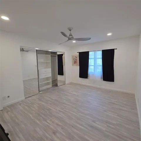 a view of an empty room with a ceiling fan