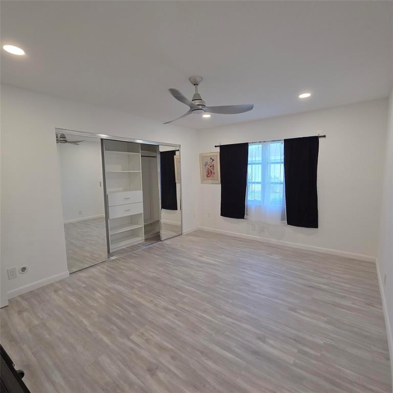 5385 Lake Front Boulevard, Unit A Delray Beach, FL 33484 - Photo 18 of 31 a view of an empty room with a ceiling fan