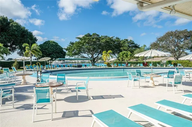 a swimming pool with outdoor seating and yard