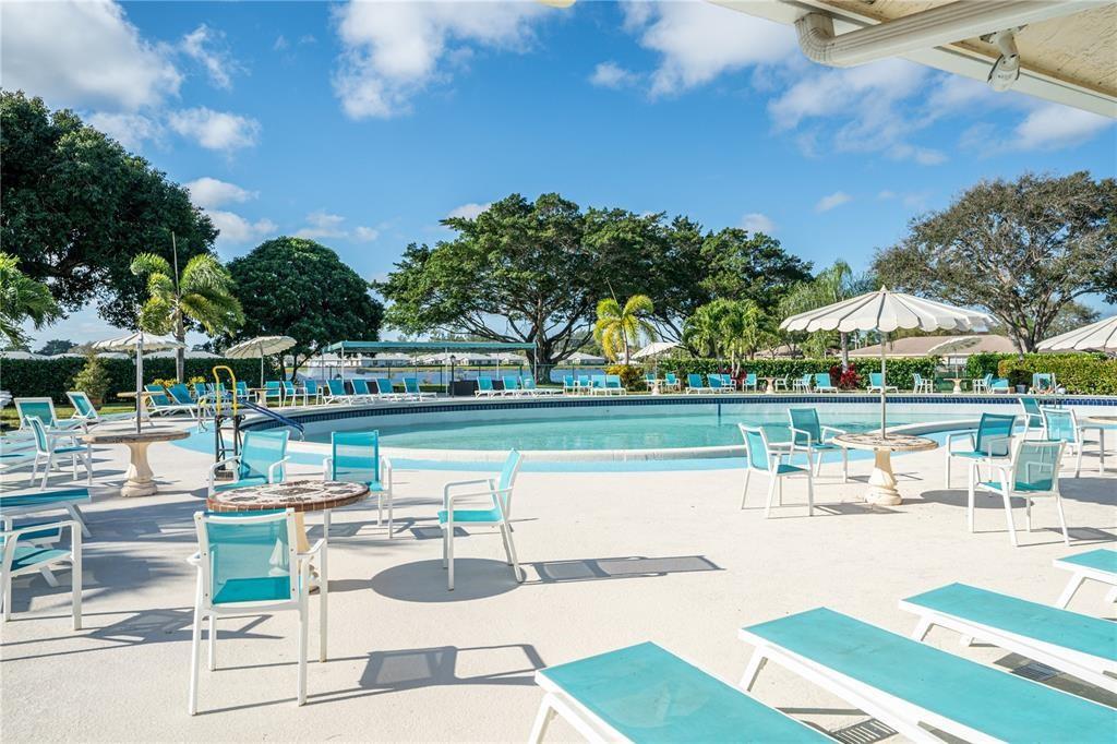 5385 Lake Front Boulevard, Unit A Delray Beach, FL 33484 - Photo 28 of 31 a swimming pool with outdoor seating and yard