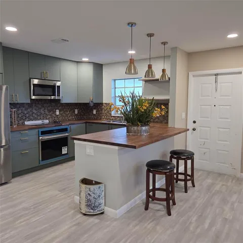a kitchen with sink cabinets and microwave