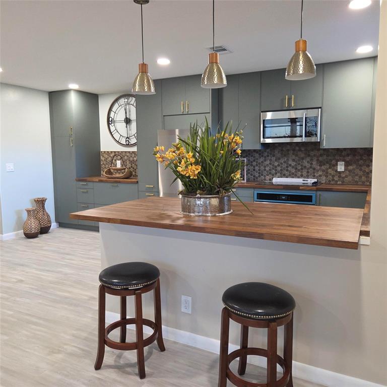 5385 Lake Front Boulevard, Unit A Delray Beach, FL 33484 - Photo 6 of 31 a kitchen with a table and chairs in it