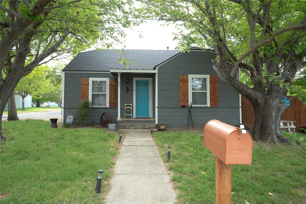a front view of a house with yard and green space