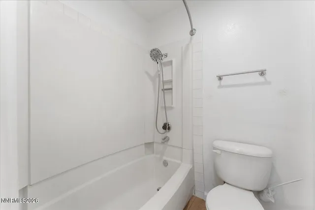 a bathroom with a toilet and a bathtub