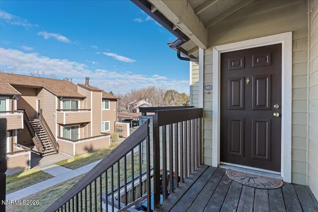 a view of a balcony with wooden floor and fence
