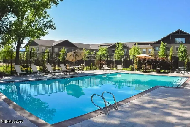 a view of swimming pool with outdoor seating and a garden