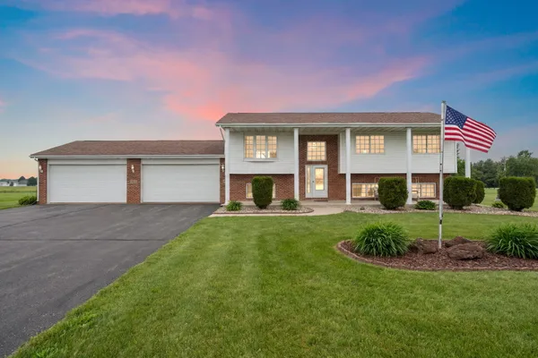 a front view of a house with a yard and garage