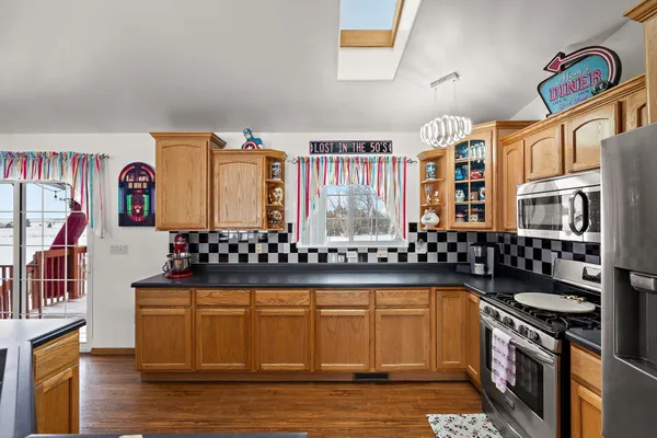 a view of staircase with lots of frames on wall and wooden floor